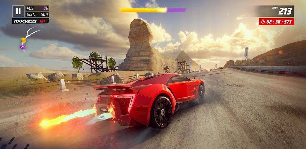 A red supercar boosting along a desert highway in Asphalt Legends Unite