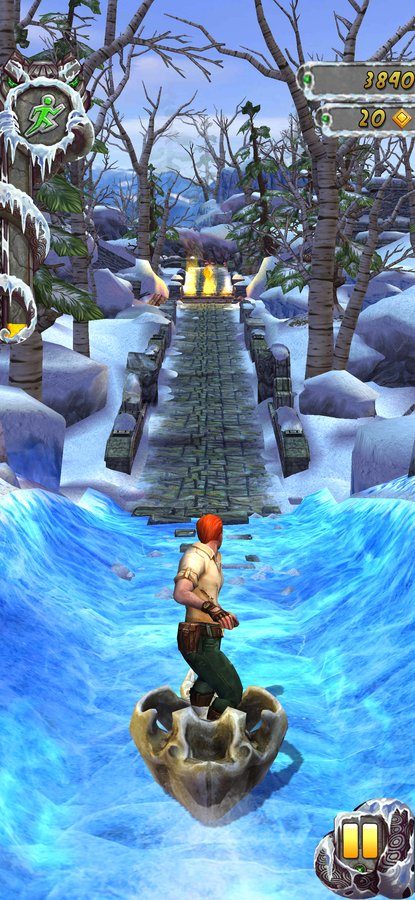 Temple Run 2 gameplay crossing a frozen river on stone ruins
